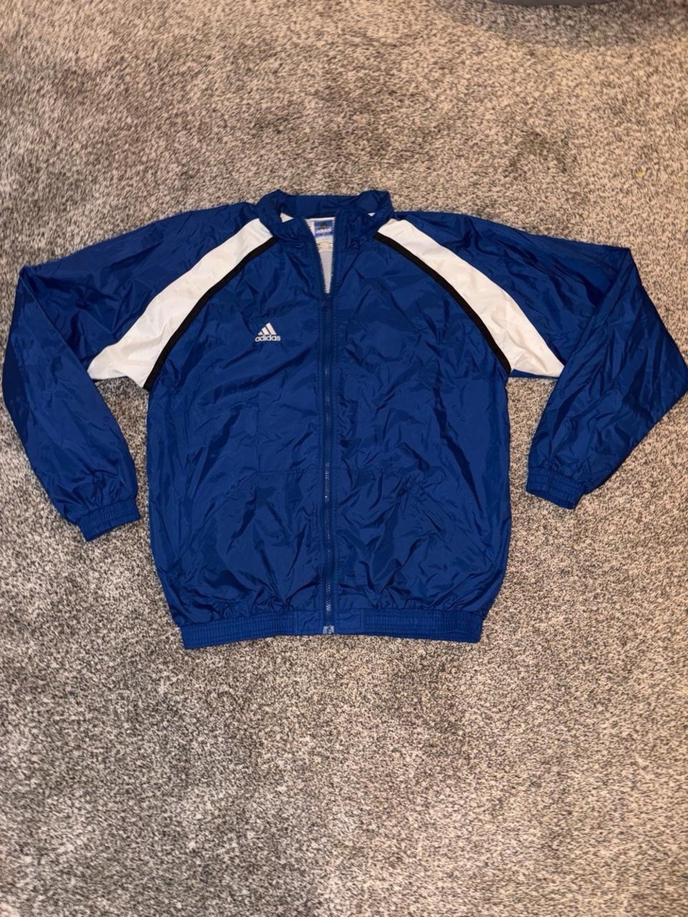 Vintage 90s Adidas blue windbreaker with white stripes on the sides